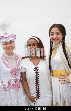 Portrait of three young multi-ethnic women in their traditional clothing, studio shot Stock Photo