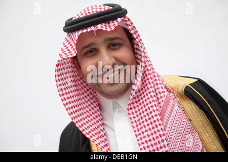 Portrait of smiling young man in traditional Arab clothing and Kaffiyeh, studio shot Stock Photo