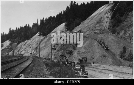 View shows method of excavating high cuts. Cutting at top done by D8 cat. with rooter and bulldozer attachments. 298230 Stock Photo