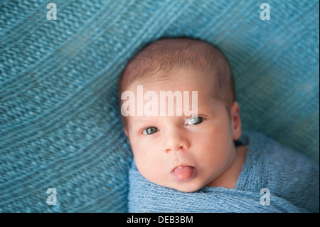 Newborn Baby Boy Sticking Out his Tongue Stock Photo