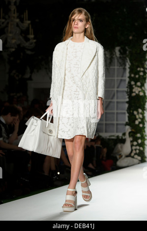 A model wears a design created by Mulberry during London Fashion Week Spring/Summer 2014. Stock Photo