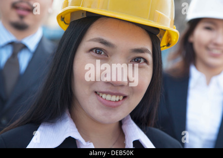 Portrait of three architects wearing hardhats, Beijing Stock Photo
