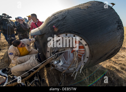 Russian Space Agency personnel assist in removing the crew of a Soyuz TMA-08M spacecraft after landing with Expedition 36 crew in a remote area September 11, 2013 near the town of Zhezkazgan, Kazakhstan. Vinogradov, Misurkin and Cassidy returned to Earth after five and a half months on the International Space Station. Stock Photo