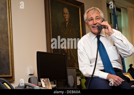 US Secretary of Defense Chuck Hagel speaks on the phone with Cmdr. Tom Dickinson, Commanding Officer of the USS Barry operating in the eastern Mediterranean Sea from his office in the Pentagon September 11, 2013 in Arlington, VA. Secretary Hagel called to thank service members for their sacrifice on the anniversary of 9/11. Stock Photo