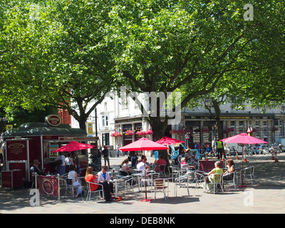 People enjoying lunchtime Coffee at an independent Coffee kiosk with outdoor seating, in Guildhall Square, Portsmouth, England. Stock Photo