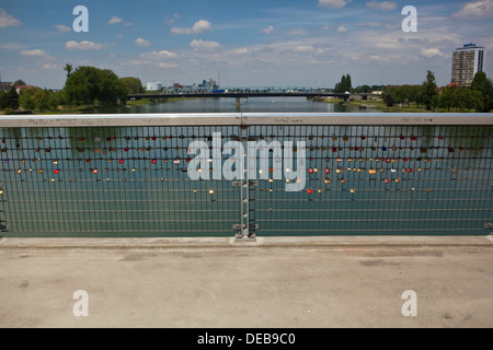 Padlocks representing love locked on to a bridge over the Rhine river Stock Photo