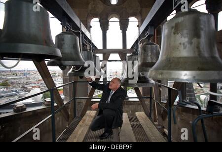 Berlin, Germany. 15th Sep, 2013. Project manager Raphael Abrell checks the church bells of the Kaiser Wilhelm Memorial Church in Berlin, Germany, 15 September 2013. The tower of the church has been refurbished and the restored chime rang at twelve noon. Photo: BRITTA PEDERSEN/dpa/Alamy Live News Stock Photo