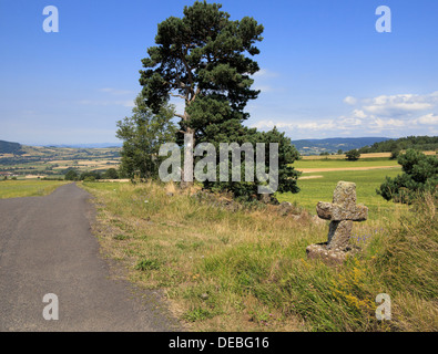 In the commune of Siaugues-Ste-Marie in the Haute Loire department of the Auvergne in France, a stone cross at the roadside. Stock Photo