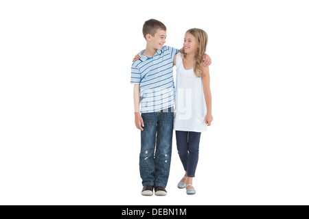 Smiling young brother and sister holding each other Stock Photo