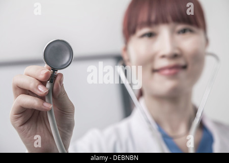 Portrait of female doctor holding a stethoscope, Close-Up Stock Photo