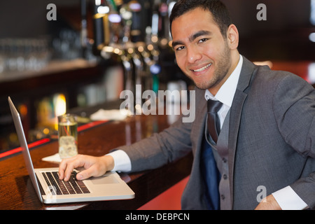 Smiling businessman working on his laptop Stock Photo