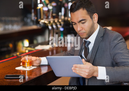 Serious businessman working on his tablet computer Stock Photo