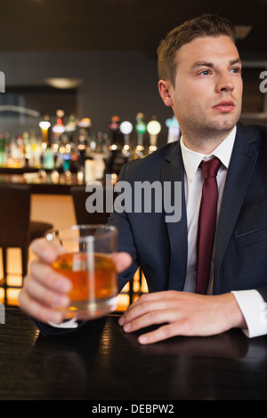 Thoughtful businessman having a drink Stock Photo