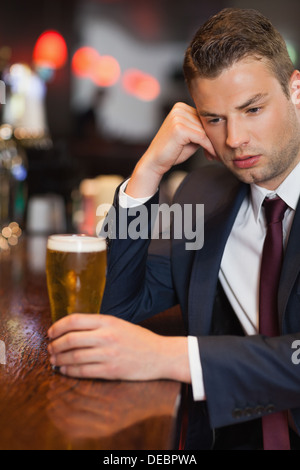 Pensive businessman having a drink Stock Photo