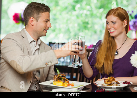 Cheerful couple having dinner together Stock Photo