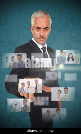 Mature stylish businessman using futuristic interface Stock Photo