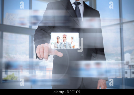 Classy businessman in bright office presenting digital interface Stock Photo