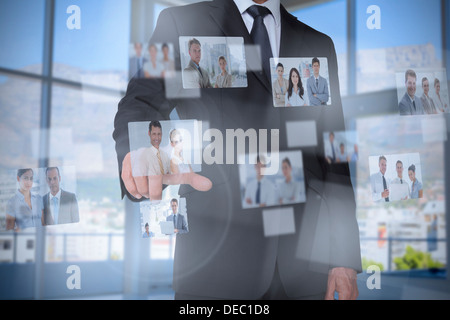 Stylish businessman presenting coworkers pictures Stock Photo