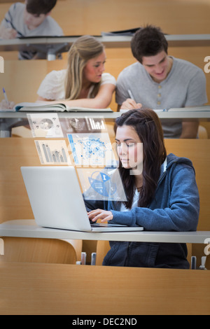 Pretty brunette studying on her digital laptop Stock Photo
