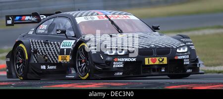 Oschersleben, Germany. 15th Sep, 2013. The Canadian BMW-Pilot Bruno Spengler drives his race car on the racetrack of the 8th race of the DTM in the etropolis Motorsport Arena in Oschersleben, Germany, 15 September 2013. Photo: JENS WOLF/dpa/Alamy Live News Stock Photo