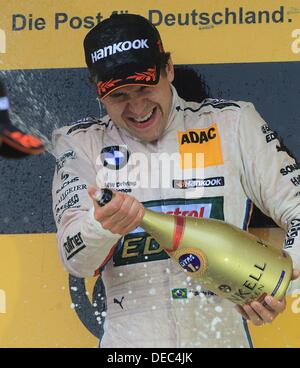 Oschersleben, Germany. 15th Sep, 2013. The Brazilian BMW-Pilot Augusto Farfus cheers after winning the 8th race of the DTM at the etropolis Motorsport Arena in Oschersleben, Germany, 15 September 2013. Photo: JENS WOLF/dpa/Alamy Live News Stock Photo