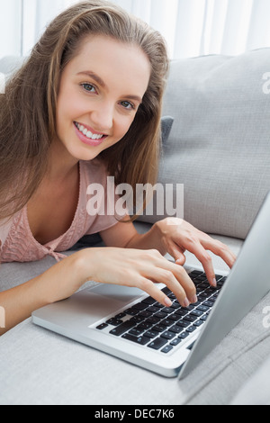 Woman using laptop on sofa Stock Photo