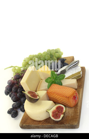 different types of cheese on a wooden board Stock Photo