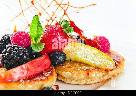 Dessert with baked apples, fresh berries and mint leaves Stock Photo