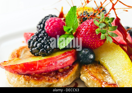 Dessert with baked apples, fresh berries and mint leaves Stock Photo