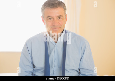 Content man looking at camera sitting on a bed Stock Photo