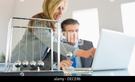 Businesswoman explaining something on the computer to a concentrated businessman Stock Photo