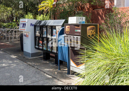 Row of USPS mailbox, FedEx Express and UPS package collection boxes and ...