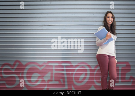 Happy student holding notebook posing Stock Photo