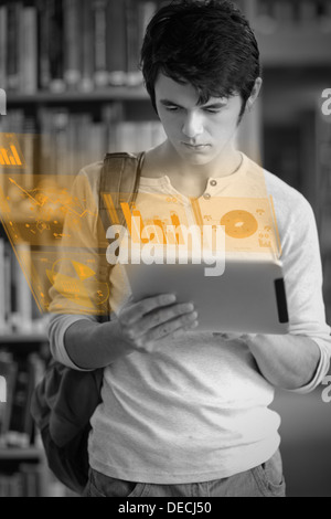 Focused handsome student working on his futuristic tablet Stock Photo