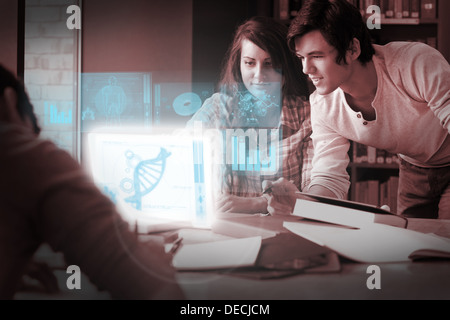 Focused students analysing dna on digital interface Stock Photo