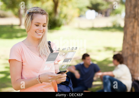 Pretty blonde working on her digital smartphone Stock Photo