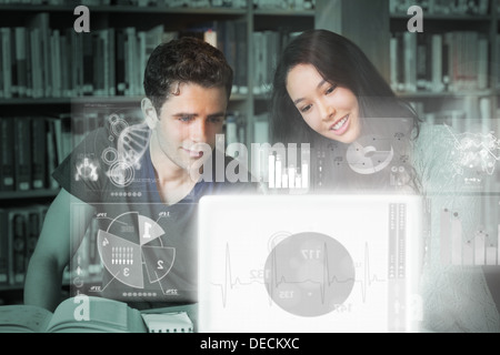 Cheerful college friends studying on digital interface Stock Photo