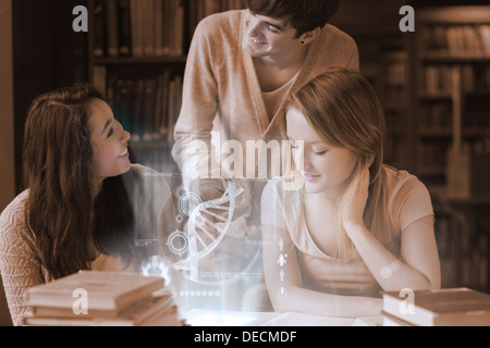 Cheerful students working together with futuristic interface Stock Photo