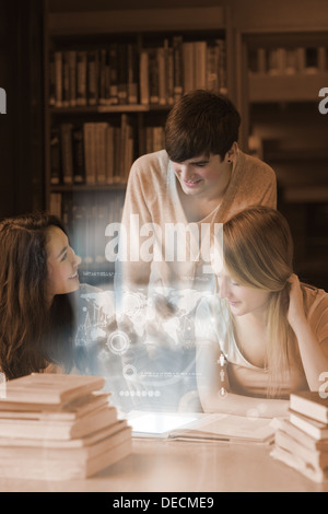 Happy students working together on international trade with futuristic interface Stock Photo