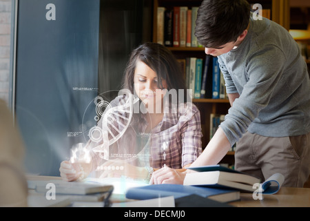 Concentrated college students analysing dna on digital interface Stock Photo