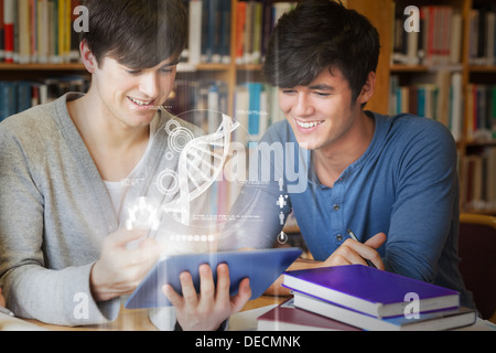 Students using futuristic hologram to learn biology from tablet Stock Photo
