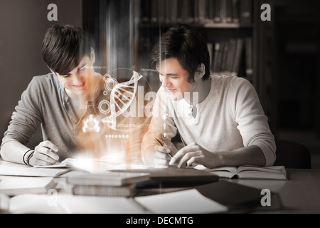 Students using futuristic interface to learn about science from digital tablet Stock Photo