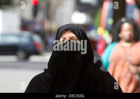 Oxford Street, London, UK. 16th Sep, 2013. A woman wears the veil in Oxford street shopping district as a  British Liberal Democrat politician  Jeremy Browne causes controversy after calling for a national debate on whether women should wear the Muslim veil or 'Niqba' in public places. Credit:  amer ghazzal/Alamy Live News Stock Photo