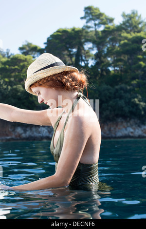 young woman in sea in Croatia Stock Photo