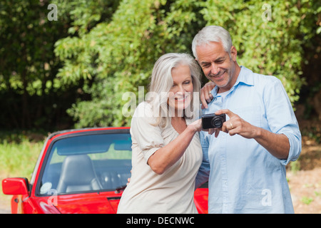 Cheerful mature woman looking at camera through hand finger heart Stock ...