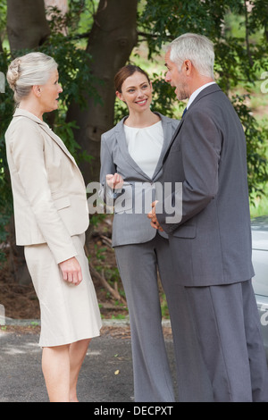 Smiling business people talking together Stock Photo