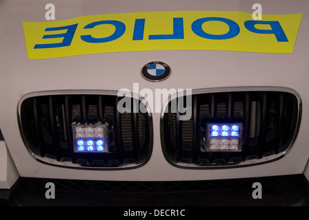 Front of BMW police car with its blue lights on, Bordon, Hampshire, UK. Stock Photo