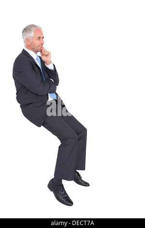 Businessman looking up while thinking Stock Photo