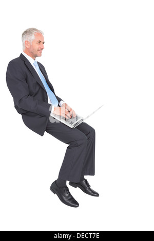 Confident mature businessman working on his laptop Stock Photo