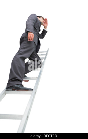 Low angle view of businessman standing on ladder Stock Photo